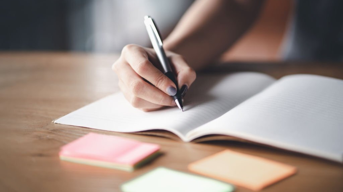 Business woman working at office with documents on his desk, Business woman holding pens and papers making notes in documents on the table, Hands of financial manager taking notes